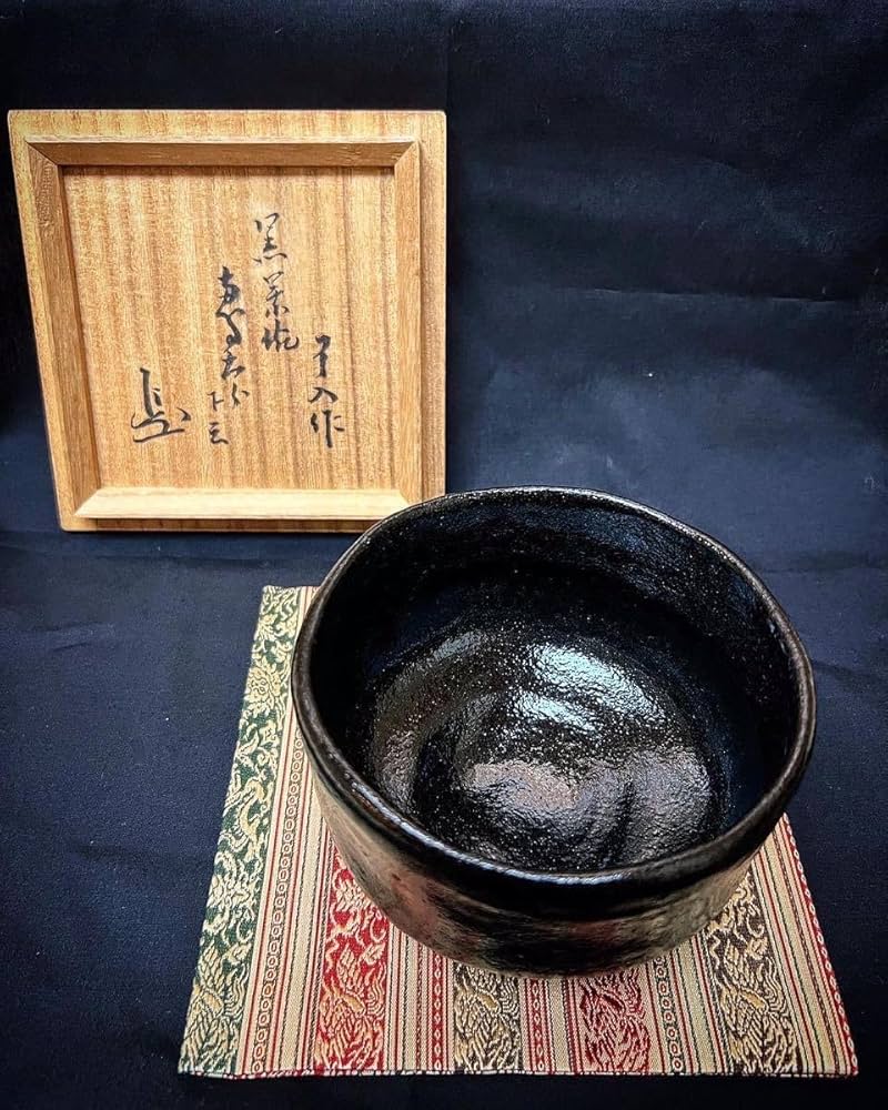 楽吉左衛門九代了入黒筒茶碗／共箱・共布／楽吉左衛門十二代弘入極め箱