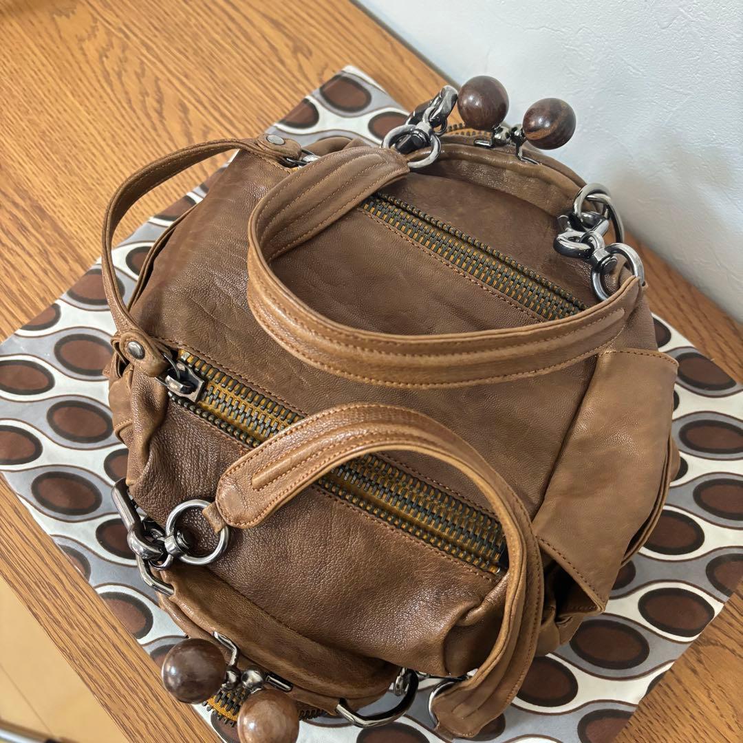 ジャマンピュエッシュ　レザー　ハンドバッグ　木製パーツ　がま口　総柄