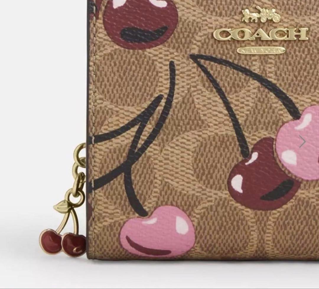 COACH シグネチャーチェリープリント二つ折り財布、さくらん